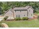Expansive backyard with well-maintained lawn, mature trees, and a deck for outdoor enjoyment at 310 Cross Lake, Fuquay Varina, NC 27526