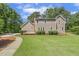 Lush green backyard with mature trees and manicured lawn, exterior angle of home with backyard deck at 310 Cross Lake, Fuquay Varina, NC 27526