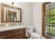 Charming powder room featuring a granite vanity and a well-lit window at 310 Cross Lake, Fuquay Varina, NC 27526