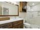 Bathroom featuring wood vanity, shower with tile surround, and updated fixtures at 310 Cross Lake, Fuquay Varina, NC 27526