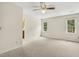 Bright, airy bedroom with two windows offering serene views and a ceiling fan at 310 Cross Lake, Fuquay Varina, NC 27526