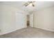 Neutral bedroom with plush carpet, ceiling fan, and closet for storage at 310 Cross Lake, Fuquay Varina, NC 27526