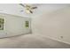 Neutral bedroom featuring carpeted floors, two windows for natural light, and a ceiling fan at 310 Cross Lake, Fuquay Varina, NC 27526