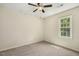 Neutral bedroom with plush carpet, ceiling fan, and window with green views at 310 Cross Lake, Fuquay Varina, NC 27526