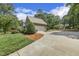 Spacious driveway leading to a charming home, surrounded by lush greenery and mature trees at 310 Cross Lake, Fuquay Varina, NC 27526