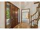 Inviting entryway featuring a wood door, staircase, and view into the living room at 310 Cross Lake, Fuquay Varina, NC 27526