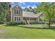 Charming home with a brick chimney, well-maintained lawn, and a cozy front porch at 310 Cross Lake, Fuquay Varina, NC 27526
