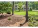 Beautiful home with a lush lawn, mature trees, and meticulous landscaping at 310 Cross Lake, Fuquay Varina, NC 27526