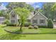 Traditional home with a pristine lawn, mature trees, and a charming front porch at 310 Cross Lake, Fuquay Varina, NC 27526