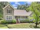 Attractive home featuring a welcoming front porch and beautiful landscaping, surrounded by lush greenery at 310 Cross Lake, Fuquay Varina, NC 27526