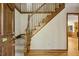 Elegant foyer with hardwood floors, wooden staircase, and natural light, showcasing classic design at 310 Cross Lake, Fuquay Varina, NC 27526