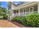 Inviting front porch with white railings, brick accents, and lush landscaping for a welcoming entrance at 310 Cross Lake, Fuquay Varina, NC 27526