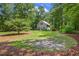 Beautiful view of the home's lush front yard with mature trees and verdant lawns at 310 Cross Lake, Fuquay Varina, NC 27526