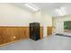 Garage interior with wood paneling, bright lighting, painted concrete floors and secure Liberty safe at 310 Cross Lake, Fuquay Varina, NC 27526