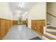 Spacious garage interior featuring wood paneling, painted concrete floors, and natural light from window at 310 Cross Lake, Fuquay Varina, NC 27526