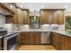 Well-lit kitchen with stainless steel appliances and custom wood cabinets at 310 Cross Lake, Fuquay Varina, NC 27526