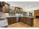 Modern kitchen with hardwood floors, custom wood cabinets, and stone countertops at 310 Cross Lake, Fuquay Varina, NC 27526