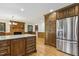 Kitchen island with granite countertop, stainless fridge, and views into Gathering room at 310 Cross Lake, Fuquay Varina, NC 27526