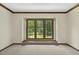 Bright living room with large window and view of the landscaped yard at 310 Cross Lake, Fuquay Varina, NC 27526