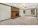 Spacious living room with a brick fireplace, neutral carpet, and natural light at 310 Cross Lake, Fuquay Varina, NC 27526