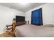 Bedroom featuring wood floors, large windows with drapes, and ample space at 313 Colleton Rd, Raleigh, NC 27610