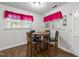 Cozy dining area with a round table and seating for four, bathed in natural light from multiple windows at 313 Colleton Rd, Raleigh, NC 27610
