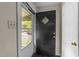The home's entryway with view of the screen door and a black front door, and white trim at 313 Colleton Rd, Raleigh, NC 27610