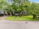 Attractive home with a lush lawn and mature trees, offering a serene and inviting atmosphere at 313 Colleton Rd, Raleigh, NC 27610