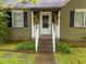 Close-up of the front porch, featuring a white railing, black awning, and decorative flower boxes at 313 Colleton Rd, Raleigh, NC 27610