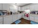 Functional kitchen featuring white cabinetry, essential appliances, and ample counter space for meal preparation at 313 Colleton Rd, Raleigh, NC 27610
