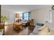 Cozy living room with neutral walls, wood floors, and a comfortable seating area with bright window curtains at 313 Colleton Rd, Raleigh, NC 27610