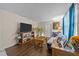 Comfortable living room with wood floors, modern furniture, and natural light coming through blue-toned curtains at 313 Colleton Rd, Raleigh, NC 27610