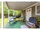 Cozy covered patio featuring outdoor seating, a grill, and a view of the backyard, perfect for relaxing and entertaining at 313 Colleton Rd, Raleigh, NC 27610