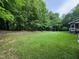 Spacious backyard offering plenty of room for outdoor activities surrounded by lush greenery and mature trees at 327 Beavertail Rd, Henderson, NC 27537