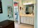 Inviting bathroom with a large mirror, vanity and a view of the commode with a window at 327 Beavertail Rd, Henderson, NC 27537
