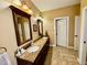 Bathroom featuring dual vanities with granite countertop and tile floor at 327 Beavertail Rd, Henderson, NC 27537
