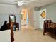 Spacious bedroom with neutral carpet leading to a vanity, crib and bathroom at 327 Beavertail Rd, Henderson, NC 27537