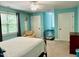 Relaxing bedroom with blue walls, carpet, and ample natural light from a large window at 327 Beavertail Rd, Henderson, NC 27537