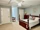 Charming bedroom featuring a four-poster bed, neutral carpet, and a ceiling fan for comfortable living at 327 Beavertail Rd, Henderson, NC 27537