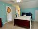 Comfortable bedroom with blue walls, neutral carpet and an ensuite bathroom at 327 Beavertail Rd, Henderson, NC 27537