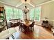Dining room with beautiful windows, hardwood floors, chandelier and wooden table at 327 Beavertail Rd, Henderson, NC 27537
