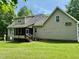 Side and rear exterior view of house with porch and mature trees at 327 Beavertail Rd, Henderson, NC 27537