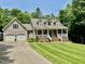 Charming home with manicured lawn, attached garage, and inviting front porch at 327 Beavertail Rd, Henderson, NC 27537