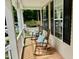 Charming front porch with rocking chairs and decorative pillows, inviting relaxation and curb appeal at 327 Beavertail Rd, Henderson, NC 27537
