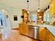 Eat-in kitchen with wood cabinets, granite counters, stainless dishwasher, and pendant lights at 327 Beavertail Rd, Henderson, NC 27537