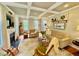 Sun-filled living room features a cozy fireplace, coffered ceilings, and hardwood floors at 327 Beavertail Rd, Henderson, NC 27537