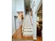 Carpeted staircase with hardwood floors and railing leading to the upper level at 327 Beavertail Rd, Henderson, NC 27537