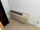 Close-up of the in-wall heating unit with adjacent shelf and outlet at 327 Beavertail Rd, Henderson, NC 27537