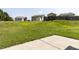 Large grassy backyard with a concrete patio area, ideal for relaxation and outdoor gatherings at 3507 Portico Ln, Durham, NC 27703