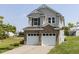 Two-story home with vinyl siding, brick base, and two-car garage with a view of the backyard at 3507 Portico Ln, Durham, NC 27703